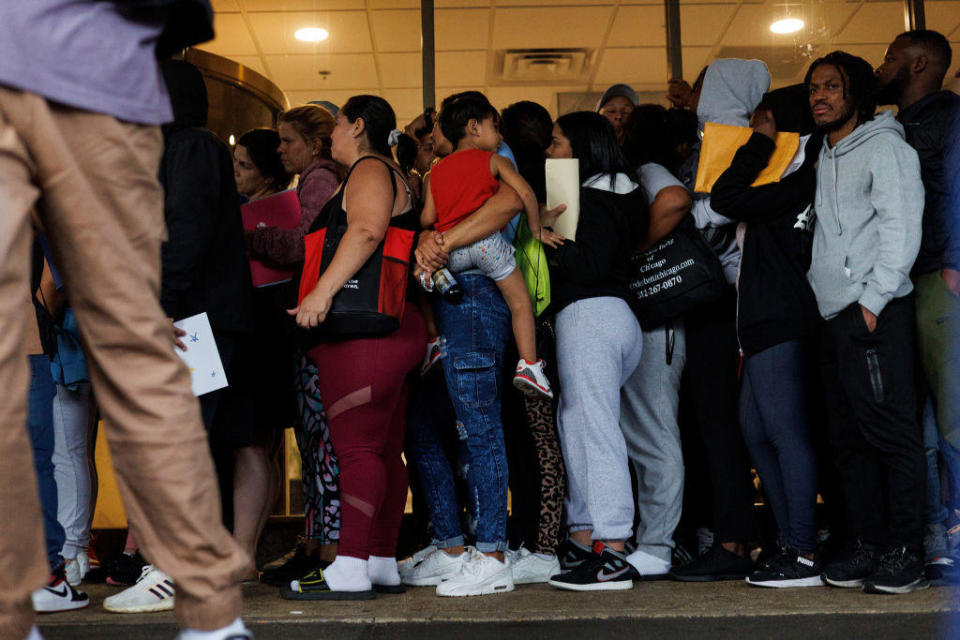 A group of migrants and members of the public wait in line outside an Illinois Department of Human Services office on Sept. 25, 2023, in Chicago. / Credit: Armando L. Sanchez/Chicago Tribune/Tribune News Service via Getty Images