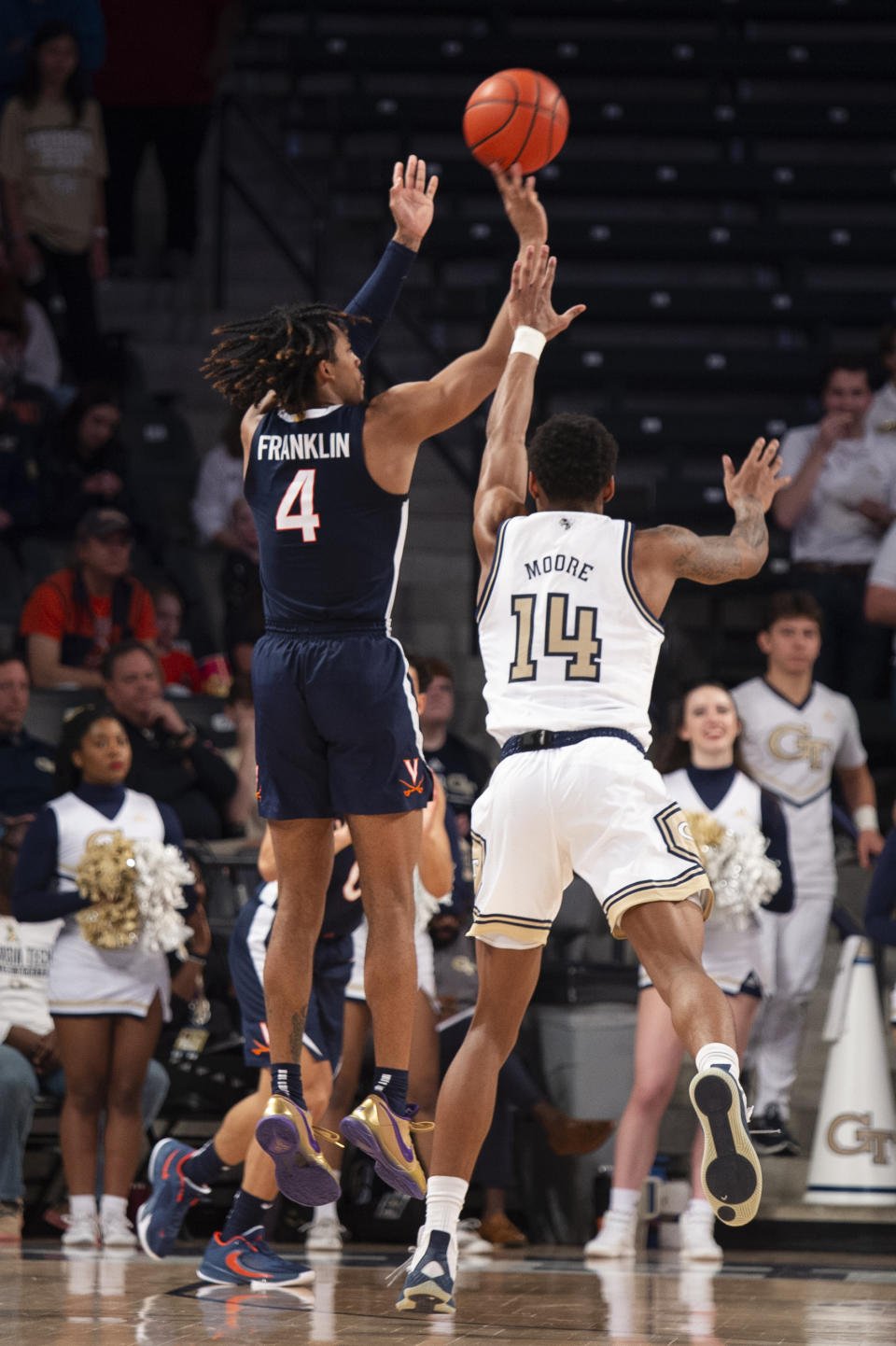 Virginia guard Armaan Franklin shoots a 3-pointer ahead of Georgia Tech forward Jalon Moore in the second half of an NCAA college basketball game, Saturday, Dec. 31, 2022, in Atlanta. (AP Photo/Hakim Wright Sr.)