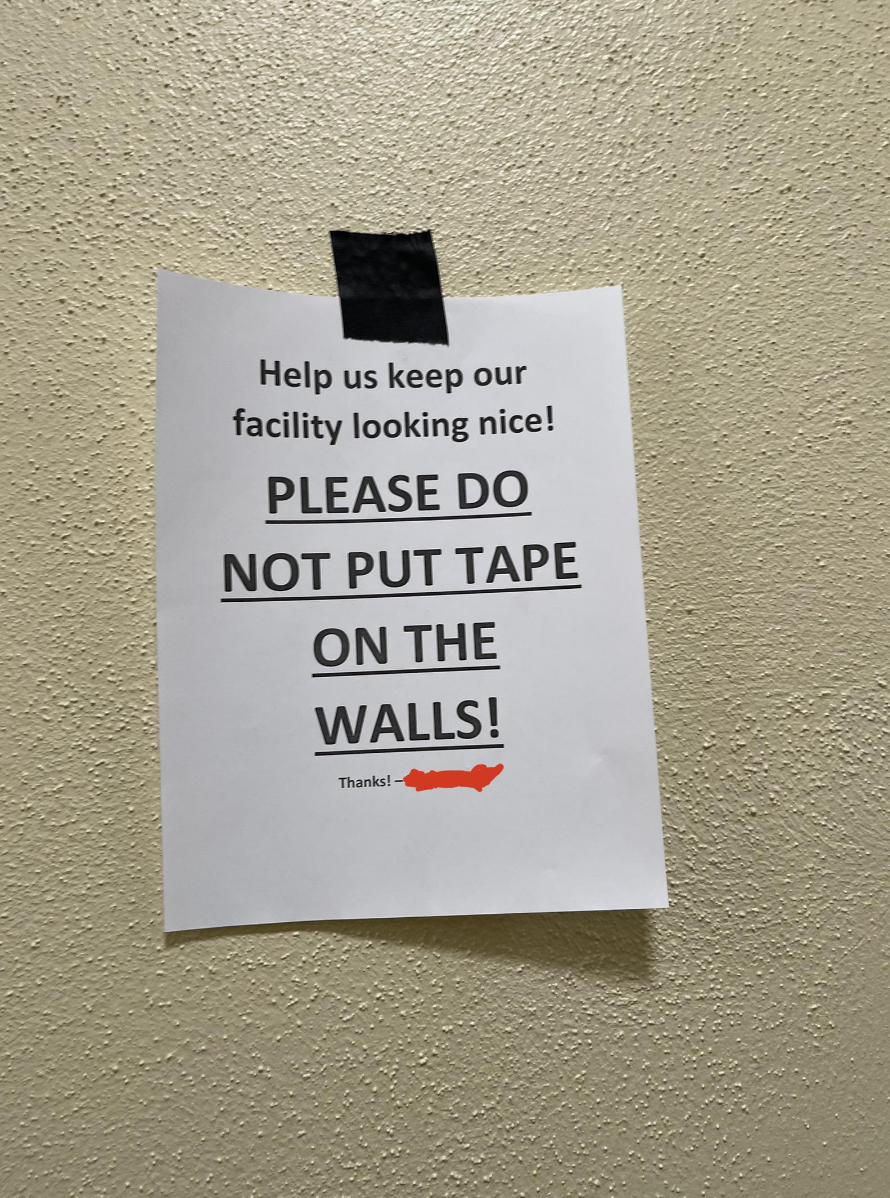 Taped sign on school wall: "PLEASE DO NOT PUT TAPE ON THE WALLS!"