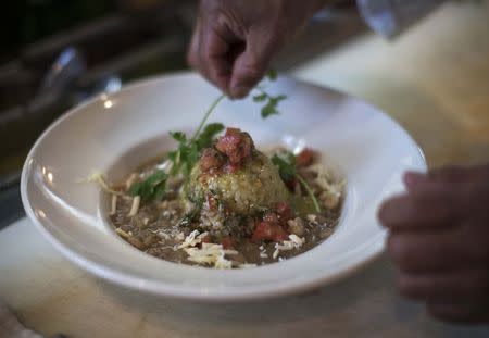 A Signature White Chili plate is prepared at Kate Mantilini restaurant in Beverly Hills, California June 4, 2014. REUTERS/Mario Anzuoni