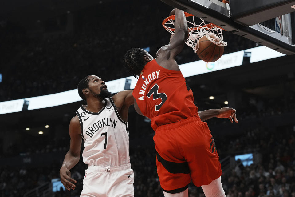 Brooklyn Nets forward Kevin Durant (7) defends as Toronto Raptors forward O.G. Anunoby (3) dunks during the first half of an NBA basketball game Wednesday, Nov. 23, 2022, in Toronto. (Chris Young/The Canadian Press via AP)