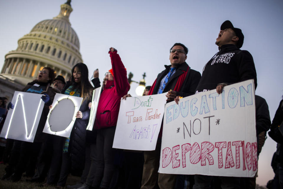 Demonstrators hold signs during a rally supporting the Deferred Action for Childhood Arrivals program (DACA). (Getty)