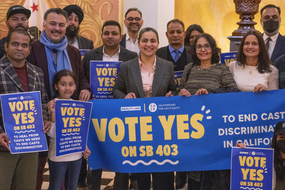 Califiornia state Sen. Aisha Wahab, center, stands with supporters following a news conference where she proposed SB 403, a bill which adds caste as a protected category in the state’s anti-discrimination laws, in Sacramento, Calif., Wednesday, March 22, 2023. California may become the first state in the nation to outlaw caste-based bias, a safeguard people of South Asian descent say is necessary to protect them from discrimination in housing, education and the tech sector where they hold key roles. (AP Photo/José Luis Villegas)