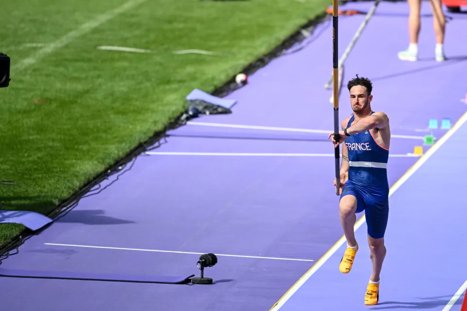 Athlete attempting a pole vault during an event, with a focus on the run-up phase. The athlete is wearing a sports uniform that says "France."