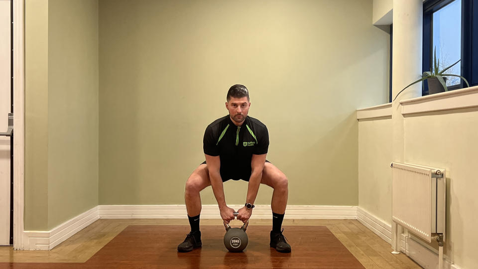 Sam Quinn, strength coach at Nuffield Health, demonstrates a sumo lift