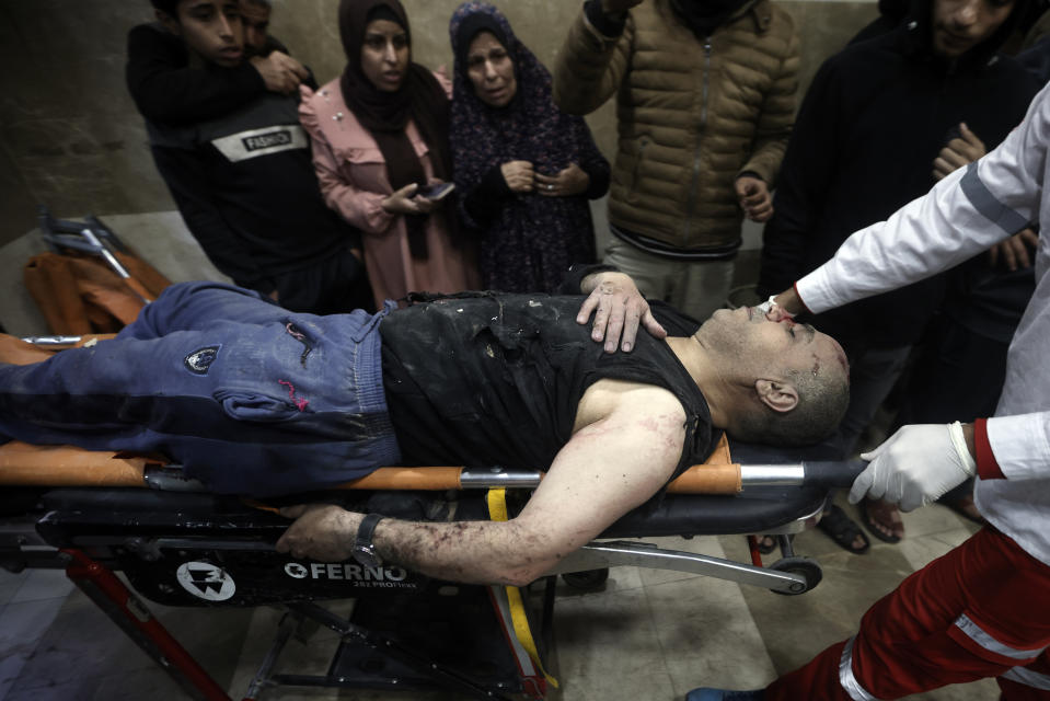 A Palestinian man wounded in Israeli bombardment, is brought to the hospital in Khan Younis refugee camp, southern Gaza Strip, Thursday, Jan. 11, 2024. (AP Photo/Mohammed Dahman)