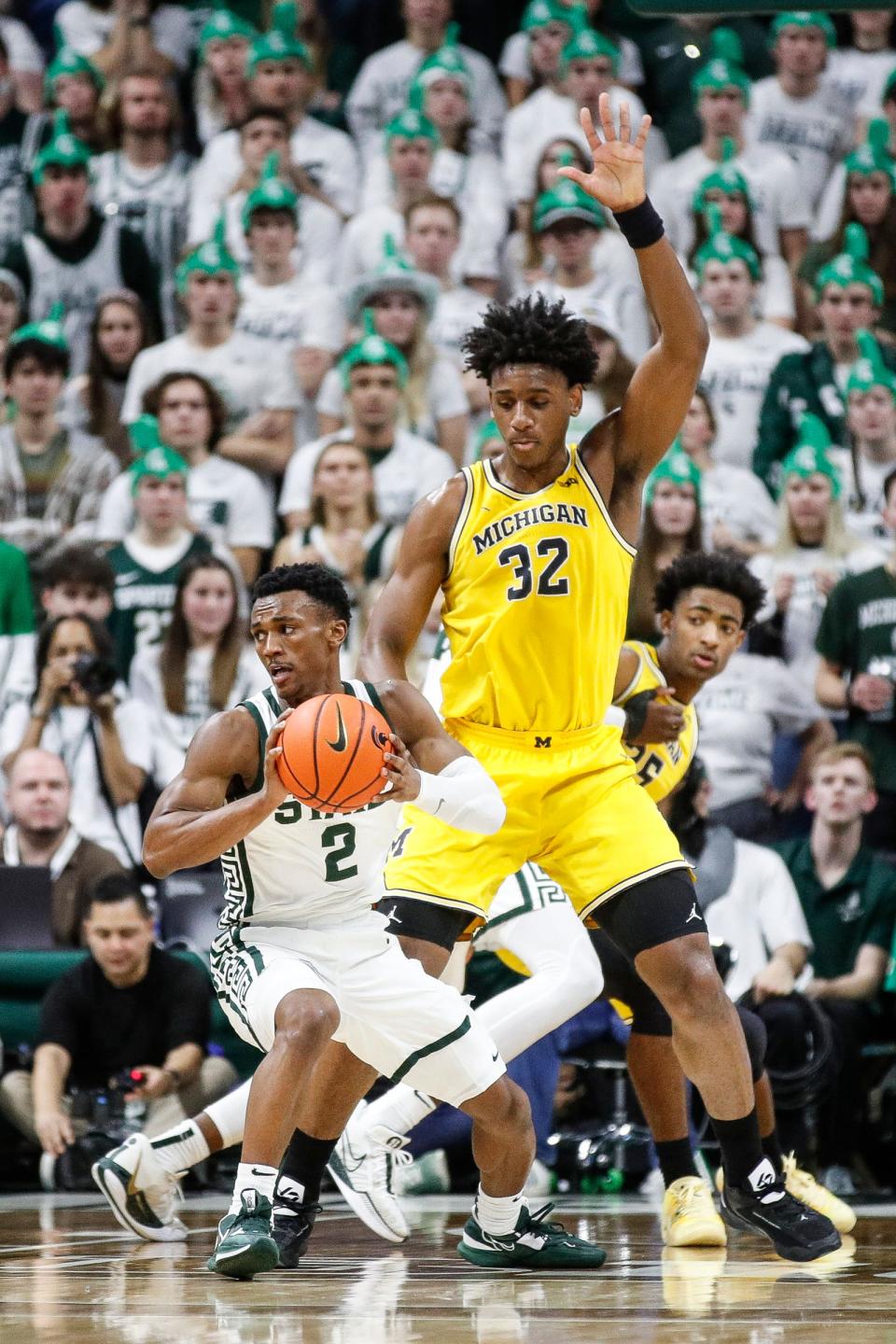 Michigan State guard Tyson Walker (2) looks to pass against Michigan forward Tarris Reed Jr. (32) during the first half at Breslin Center in East Lansing on Tuesday, Jan. 30, 2024.