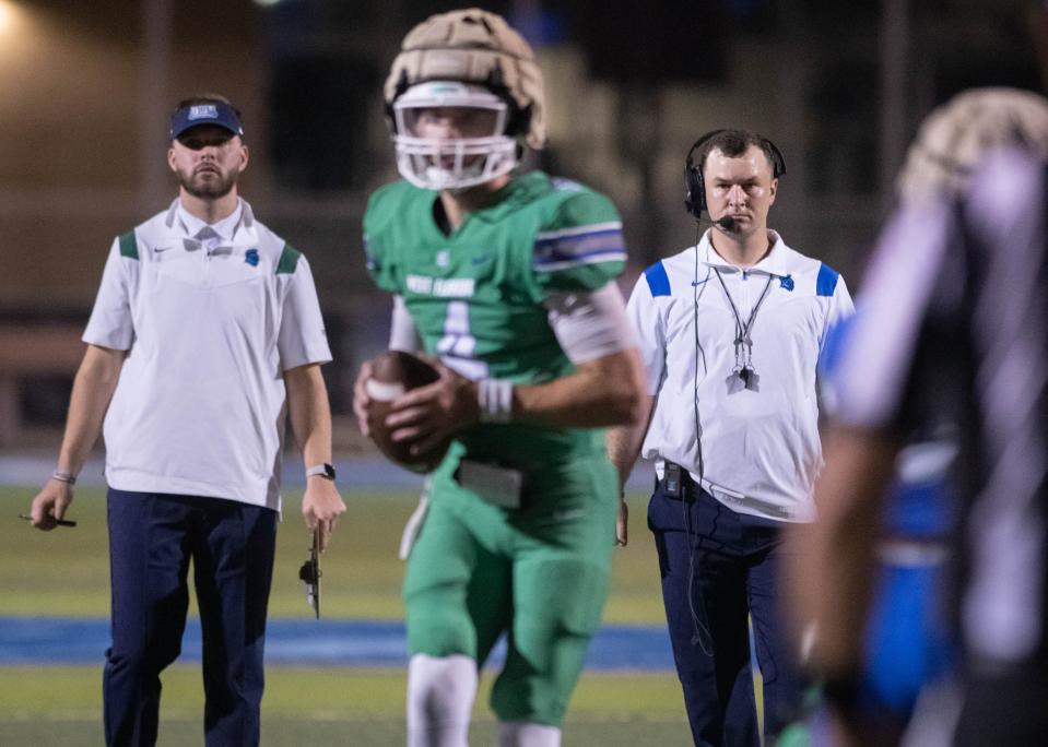 Head coach Kaleb Nobles, right, keeps an eye on the action during the spring football game at the University of West Florida in Pensacola on Thursday, March 9, 2023.