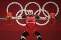 Anton Pliesnoi of Georgia competes in the men's 96kg weightlifting event, at the 2020 Summer Olympics, Saturday, July 31, 2021, in Tokyo, Japan. (AP Photo/Luca Bruno)