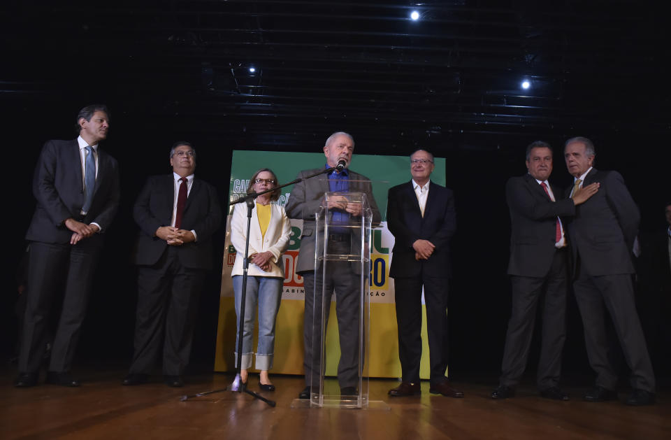 Brazil's President-elect Luiz Inacio Lula da Silva, center, announces some of his ministers during a press conference at his transition team's headquarters in Brasilia, Brazil, Friday, Dec. 9 2022. Lula da Silva revealed on Friday some of the faces that will compose his future administration, starting Jan. 1, including his much-awaited pick for Finance Minister: former Sao Paulo mayor Fernando Haddad. (AP Photo/Ton Molina)