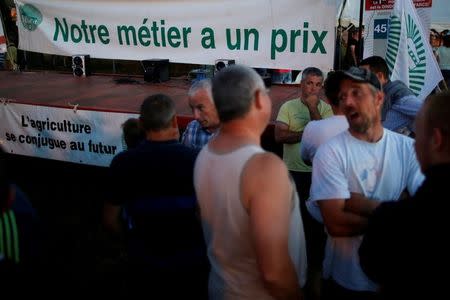 French dairy farmers from the FNSEA union block the round-about access to the Lactalis plant as they protest against the price of milk in Laval, France, August 22, 2016. REUTERS/Stephane Mahe