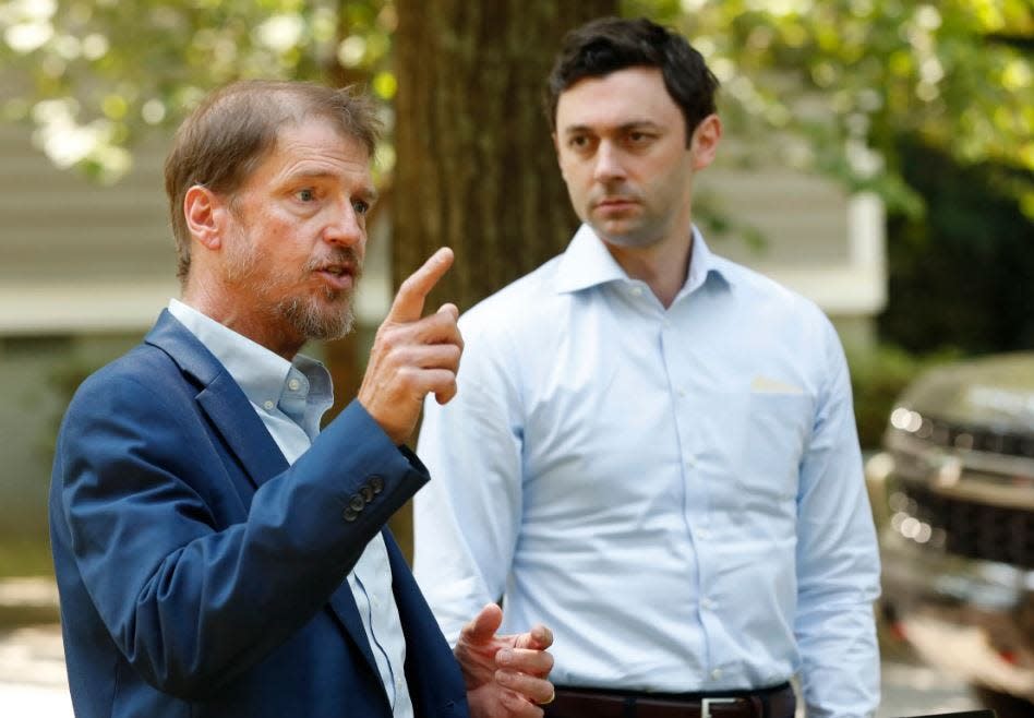 U.S. Sen. Jon Ossoff, D-Ga, looks on Wednesday, May 24, 2023, while state Rep. Spencer Frye, who is the executive director of Athens Area Habitat for Humanity, talks about the federal resources that will aid in building 40 homes in the Gaines School Elementary district of Athens.