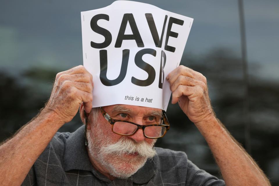 "The U.S.B. (urban service boundary) is under attack and that's why we're here today, to draw a line in the sand," said Bob Ernst, of Martin County, who puts on a handmade hat as he and other community members rally against a possible change to the rural lifestyle land-use designation outside the Martin County administration building, Tuesday, Dec. 5, 2023, at 2401 SE Monterey Rd. in Stuart. Tuesday morning, commissioners are considering a change that would amend the rural lifestyle category to allow development on at least 3,000 acres within 6,000 feet of an urban services boundary. The rule presently allows development on at least 1,000 acres adjacent to an urban services boundary.