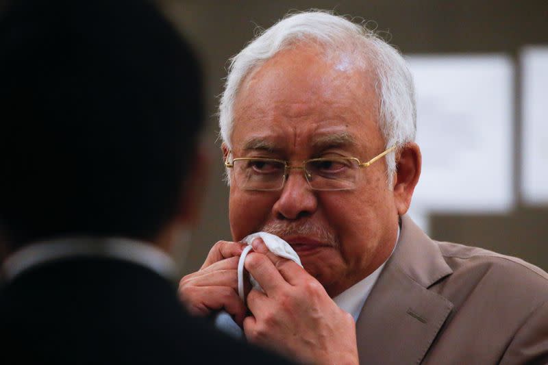 Former Malaysian Prime Minister Najib Razak reacts before leaving Kuala Lumpur High Court in Kuala Lumpur