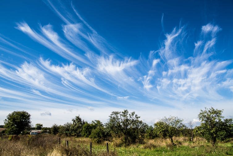 <span class="caption">Cirrus clouds can mark the approach of a warm front – and rain.</span> <span class="attribution"><a class="link " href="https://www.shutterstock.com/download/success?src=5iuKxSxH11E16yXzxBJxiw-1-6" rel="nofollow noopener" target="_blank" data-ylk="slk:Shutterstock;elm:context_link;itc:0;sec:content-canvas">Shutterstock</a></span>