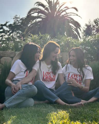 <p>Alliance of Moms/Instagram</p> Meghan Markle (right) models the Alliance of Mom's charitable new Love Like a Mother t-shirt with Kelly McKee Zajfen (center) and Abigail Spencer (left).