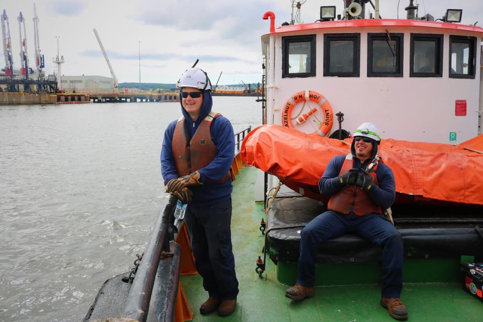 Deckhands Alex Black and Nick MacPhee on the deck of the Irving Hazelnut. The crews who work on the tugs often become 'like family,' according to most of the longtime mariners. 