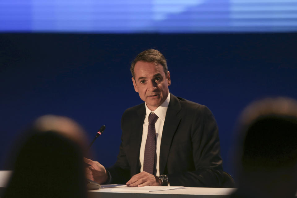 Greece's Prime Minister Kyriakos Mitsotakis waits for a news conference to start during the Thessaloniki International Fair at the northern city of Thessaloniki, Sunday, Sept. 8, 2019. Greece's prime minister said on Saturday that financial reforms such as reducing taxes, fighting bureaucracy and attracting investment must be implemented before the country asks its creditors to agree to lower budget surpluses. (AP Photo/Giannis Papanikos)