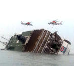 South Korean rescue helicopters fly over a South Korean passenger ship, trying to rescue passengers from the ship in water off the southern coast in South Korea, Wednesday, April 16, 2014. The South Korean passenger ship carrying more than 470 people, including many high school students, is sinking off the country's southern coast Wednesday after sending a distress call, officials said. There are no immediate reports of causalities. (AP Photo/Yonhap) KOREA OUT