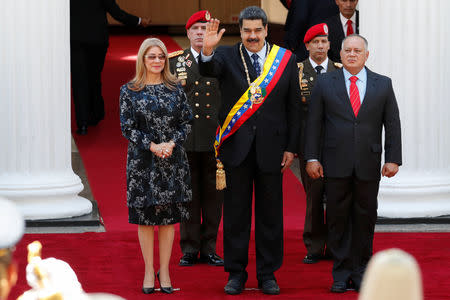 Venezuela's President Nicolas Maduro salutes next to his wife Cilia Flores and National Constituent Assembly (ANC) President Diosdado Cabello, during his arrival for a special session of the National Constituent Assembly to present his annual state of the nation in Caracas, Venezuela January 14, 2019. REUTERS/Carlos Garcia Rawlins