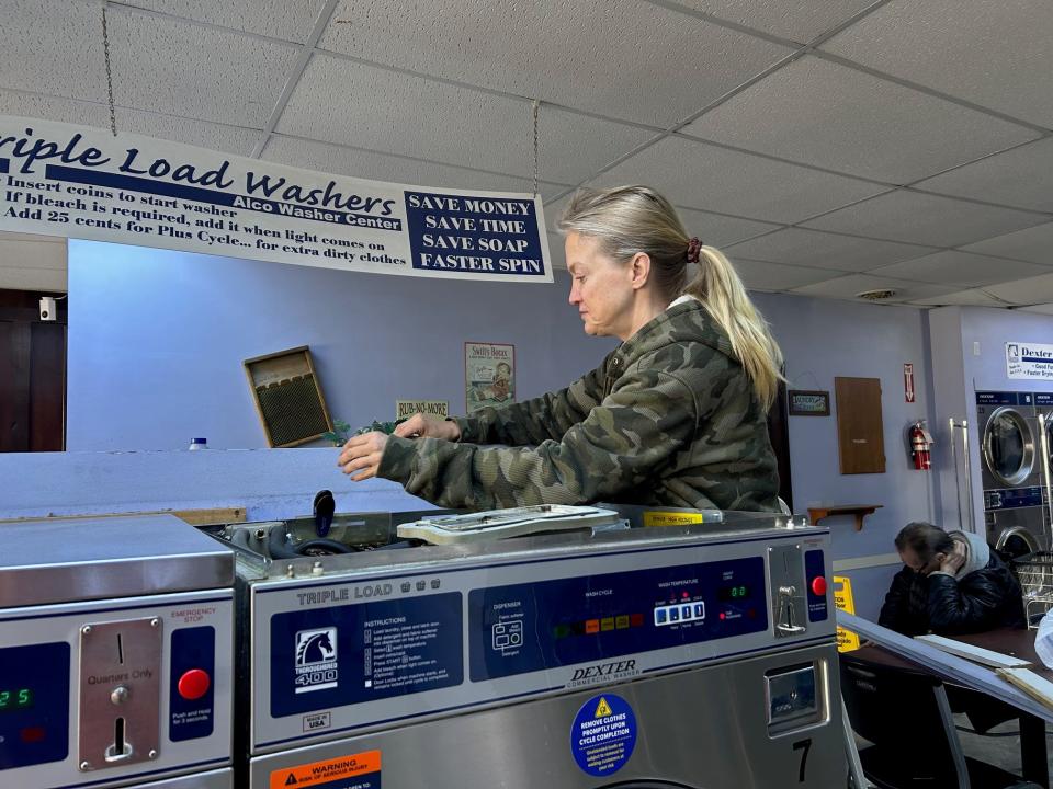 The Hometown Wash and Dry owner, Stephanie Mostoller, discusses how theft affects her business while fixing one of her washing machines.