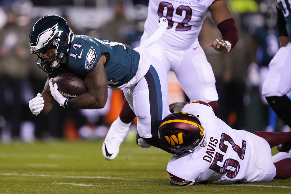 Philadelphia Eagles running back Kenneth Gainwell (14) is tackled by Washington Commanders linebacker Jamin Davis (52) during the second half of an NFL football game, Monday, Nov. 14, 2022, in Philadelphia. (AP Photo/Matt Rourke)