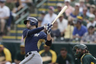 Milwaukee Brewers' Ryan Braun grounds out against the Oakland Athletics during the third inning of a spring training baseball game Thursday, Feb. 27, 2014, in Scottsdale, Ariz. (AP Photo/Gregory Bull)