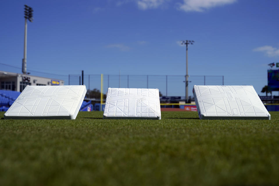 The new, larger base sits next to the older, smaller base at TD Ballpark Wednesday, Feb. 15, 2023, in Dunedin, Fla. Opening day will feature three of the biggest changes in baseball since 1969: Two infielders will be required to be on either side of second base, base size will increase to 18-inch squares from 15 and a pitch clock will be used. (AP Photo/Brynn Anderson)