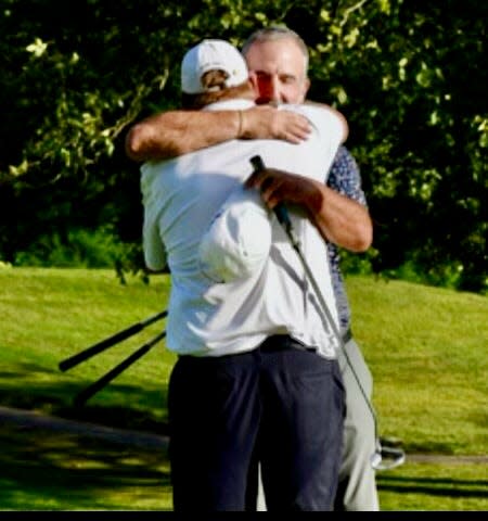 Bill Plante, with back to photo, and John Jeniski embrace after winning the Labor Day Four-Ball at Heritage CC.