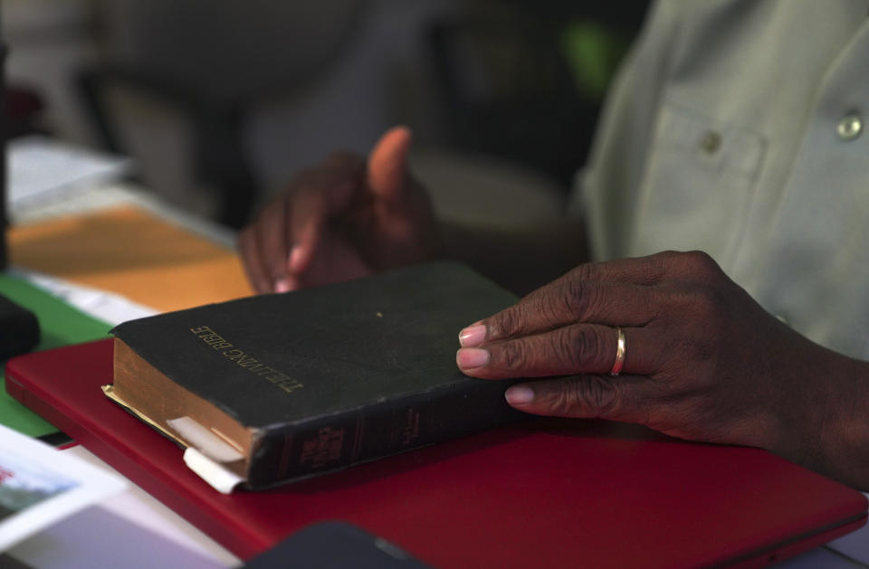 Bishop Charlesworth Browne holds his Bible while giving an interview to The Associated Press, Monday, May 15, 2023, in St. John's, Antigua. For years Browne has rallied against proposed law changes, such as the overturning of the anti-sodomy law in Antigua and Barbuda. (AP Photo/Jessie Wardarski)