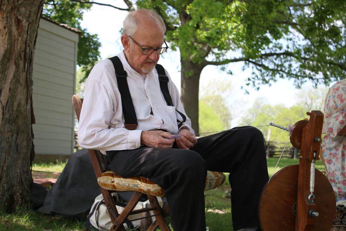 Gordon Thompkins, of the Osage Spinners and Weavers Guild, demonstrates a spinning technique at Missouri Town 1855’s sheep shearing day. Beth Lipoff/Special to the Journal