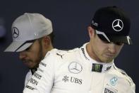 Formula One F1 - U.S. Grand Prix - Circuit of the Americas, Austin, Texas, U.S., 22/10/16. Mercedes' teammates Nico Rosberg of Germany (R) and Lewis Hamilton of Britain walk past each other as they attend a press conference following the qualifying session. Picture taken October 22, 2016. REUTERS/Adrees Latif