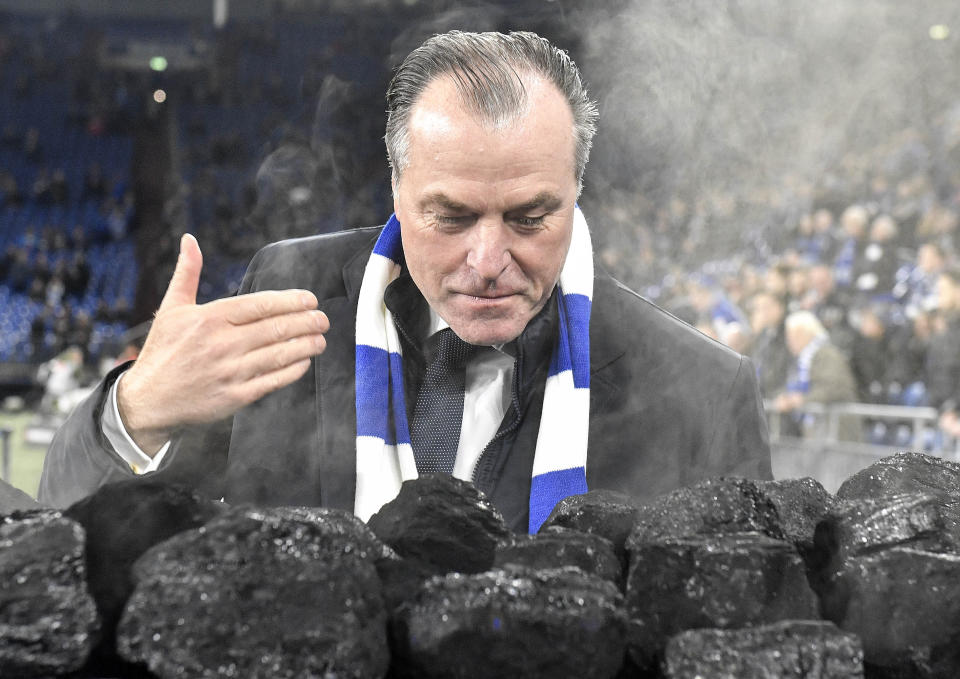 FILE-In this Dec. 19, 2018 file photo Schalke boss Clemens Toennies smells steaming coal on a trolley beside the pitch prior the Bundesliga soccer match between FC Schalke 04 and Bayer Leverkusen in Gelsenkirchen, Germany. Schalke chairman Clemens Tönnies has resisted calls to resign and will instead step down for three months over comments he made last week that were widely condemned as racist. (AP Photo/Martin Meissner)