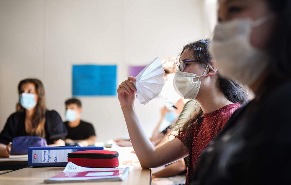 Image: Students of the eleventh grade sit with face masks in a classroom of the Phoenix high school in Dortmund, western Germany (Ina Fassbender / AFP - Getty Images)