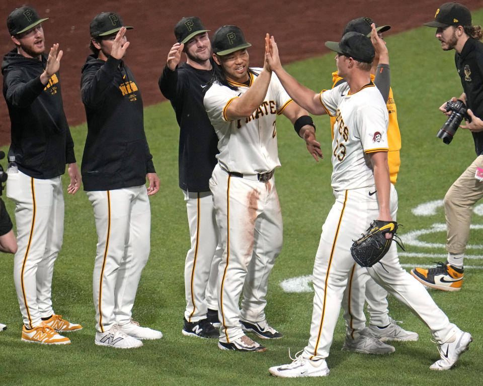 Pittsburgh Pirates pitcher Mitch Keller, right, celebrates with Connor Joe as he walks off the field after getting a complete game win over the Los Angeles Angels in a baseball game in Pittsburgh, Monday, May 6, 2024. (AP Photo/Gene J. Puskar)