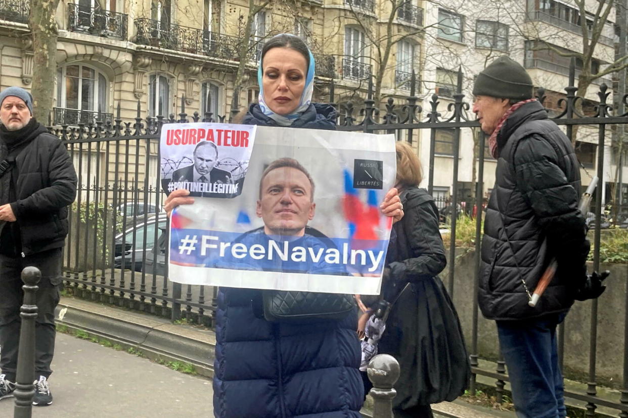 Une femme brandit une affiche représentant Alexeï Navalny, alors que le rassemblement devant l'ambassade de Russie est dispersé par la police, à Paris, le 16 février 2024.   - Credit:Lou Roméo, Le Point