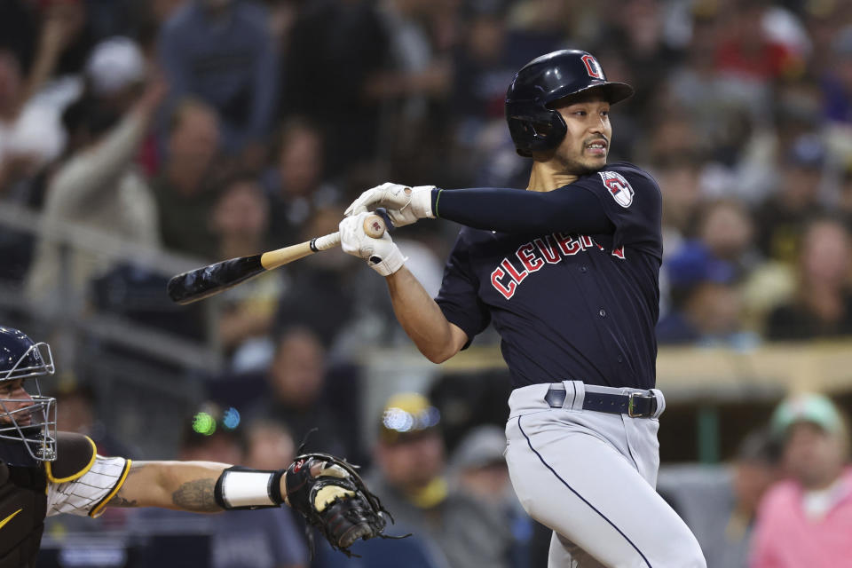 Cleveland Guardians' Steven Kwan, right, watches his hit as San Diego Padres catcher Gary Sanchez looks on in the fifth inning of a baseball game Tuesday, June 13, 2023, in San Diego. Steven Kwan was out at first and Will Brennan scored on the play. (AP Photo/Derrick Tuskan)