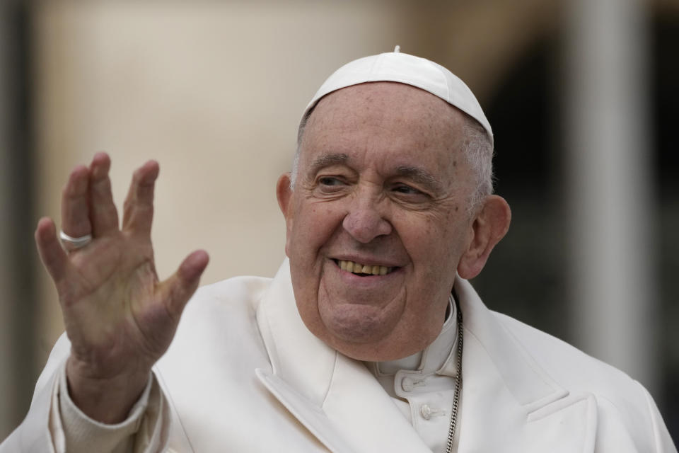 Pope Francis waves to faithful during his weekly general audience in St. Peter's Square, at the Vatican, Wednesday, March 29, 2023. Pope Francis went to a Rome hospital on Wednesday for some previously scheduled tests, slipping out of the Vatican after his general audience and before the busy start of Holy Week this Sunday. (AP Photo/Alessandra Tarantino)