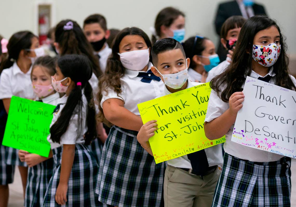 Students from St. John the Apostle Catholic School gather to greet the arrival of Gov. Ron DeSantis to a press conference at their school in Hialeah, Florida, on Tuesday, May 11, 2021. DeSantis signed a bill expanding and revamping Florida’s school scholarship and voucher programs.