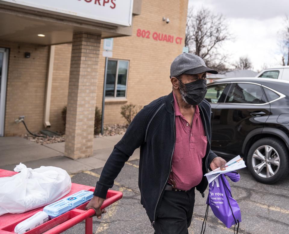 Donnie Whitfield tows a cart of donated food from the Salvation Army's food bank in Aurora, Colorado.