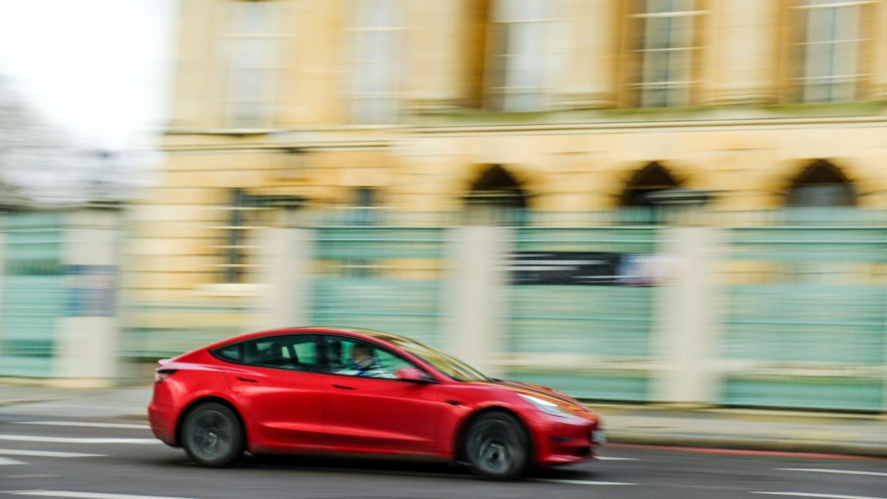 LONDON- FEBRUARY 19, 2024:  Tesla Model 3 in motion blur on London street