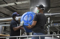 In this photo taken Friday, May 15, 2020, soup is being cooked in a beer tank at Woodstock Brewery in Cape Town, South Africa. The country has restricted the sale of cigarettes and alcohol during the coronavirus lockdown, but the brewery has adapted to the ban by using its large vats to cook meals for the poor. (AP Photo/Nardus Engelbrecht)