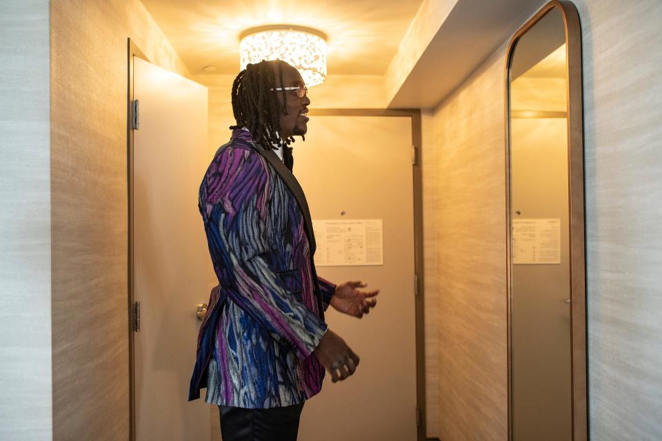 Missouri defensive lineman Darius Robinson checks his outfit in a mirror as he prepares for the red carpet event before the NFL draft in Detroit on Thursday, April 25, 2024.