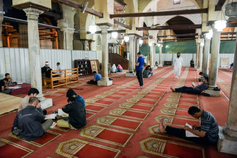 Worshippers sit, pray and read from the Koran inside the 10th century historic al-Azhar mosque in the Egyptian capital Cairo's Islamic quarter