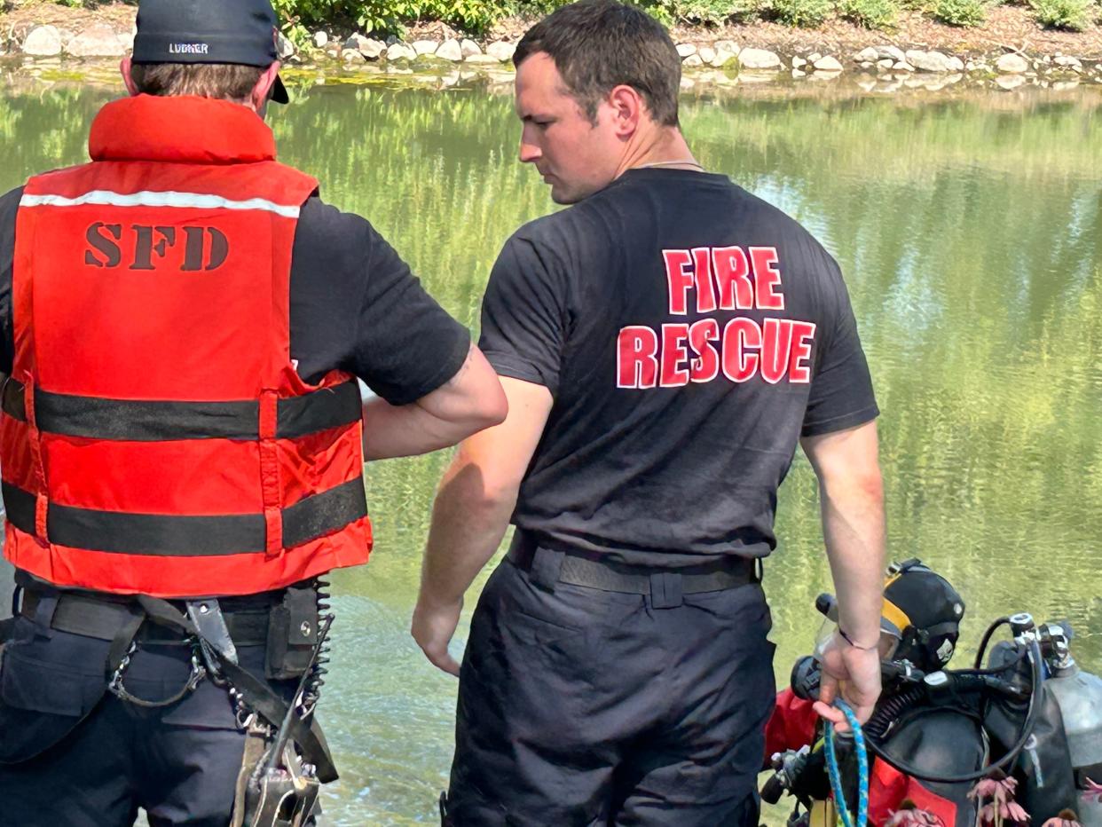 Rescue crews on scene after a man drove his vehicle off Interstate 43 and into a retention pond on the Acuity Insurance property in Sheboygan Wednesday, Aug. 23, 2023.