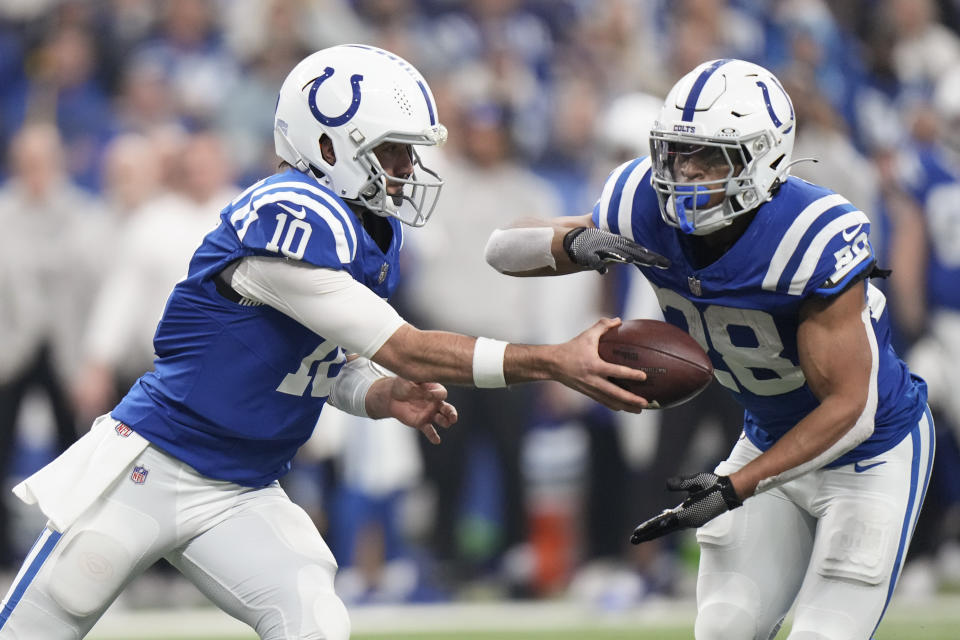 Indianapolis Colts running back Jonathan Taylor (28) gets a hand off from quarterback Gardner Minshew (10) during the first half of an NFL football game against the Las Vegas Raiders, Sunday, Dec. 31, 2023, in Indianapolis. (AP Photo/AJ Mast)