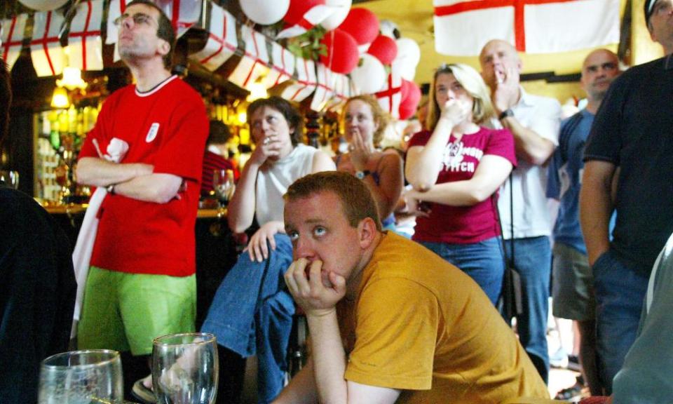 Football fans watch England play Sweden in their local pub in London on J2 June 2002.