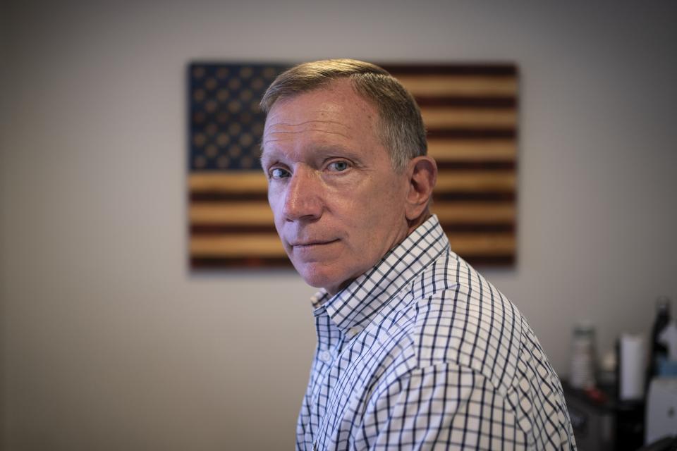 Retired NYPD Officer Ken Winkler, poses for a portrait in his office on Tuesday, Aug. 3, 2021, in New York. Winkler helped coordinate the New York Police Department Emergency Service Unit response on-scene at the World Trade Center on Sept. 11, ducking behind a truck to escape the debris when the south tower collapsed. "It went from a clear day to various shades of gray and black … from kind of organized chaos to just chaos," recalls Winkler, who now manages Manhattan's cruise ship terminal. (AP Photo/Wong Maye-E)