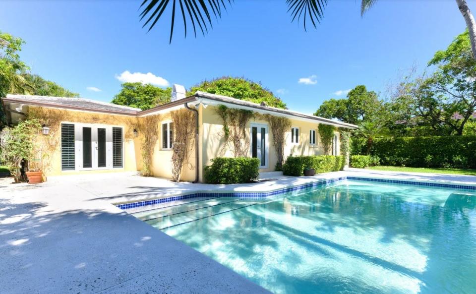 Glass doors on a house at 274 Monterey Road open onto the pool area. Owner Morton A. Pierce has the house listed for sale at $10.25 million.