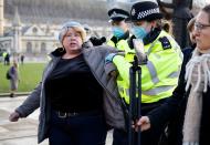 Protestors remonstrate with Police offices during an anti-COVID-19 lockdown demonstration outside the Houses of Parliament in Westminster, central London on January 6, 2021. - Britain toughened its coronavirus restrictions on Tuesday, with England and Scotland going into lockdown and shutting schools, as surging cases have added to fears of a new virus variant. (Photo by Tolga Akmen / AFP) (Photo by TOLGA AKMEN/AFP via Getty Images)